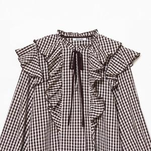 Women's brown checkered long sleeve shirt with layered ruffles and lace-up collar detail