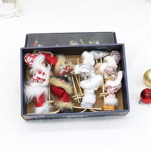 Set of four plush skiing Santa Claus ornaments in a gift box for Christmas decor