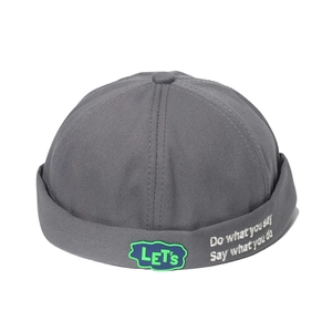 Detail of dark grey cotton Miki hat with letter patch and white side embroidery text