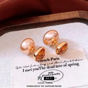 Elegant 18K gold plated earrings with pearls and amber gemstones on vintage fabric