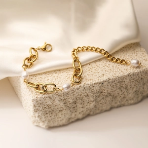 Retro 18K gold plated stainless steel chain bracelet with pearls on white silk background