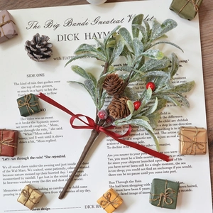 Christmas bouquet with snowy leaves, pine cones, and red berries on vintage paper