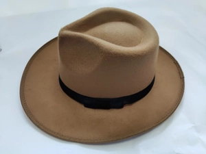 Close-up of a camel fedora hat featuring a wide brim and a classic black ribbon band