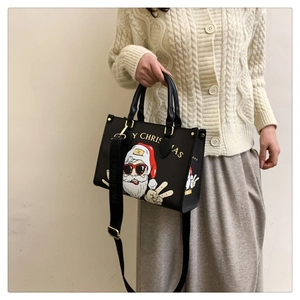 Detail of Santa Claus print on black faux leather tote bag with stylish shoulder strap