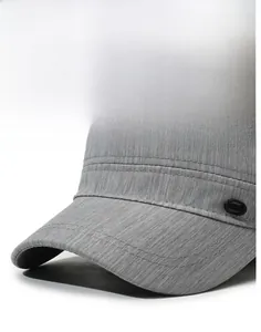 Macro view of men's grey flat top sun cap showing textured fabric and upright visor brim