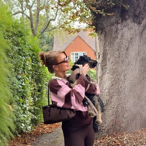 Chic pink and brown striped polo neck knit sweater styled with a brown suede shoulder bag
