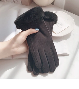 Detail of warm winter gloves for women featuring plush faux fur trim and suede texture