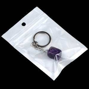 Irregular purple crystal gemstone keychain in protective PE bag packaging
