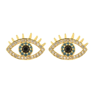 Close-up of golden Evil Eye earrings with white rhinestones and blue bead details