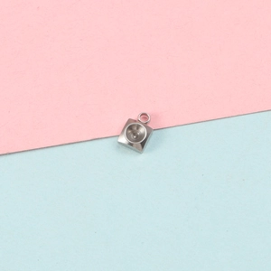 Close-up of a polished stainless steel square bezel pendant tray for jewelry making