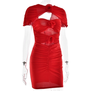 Detail of red ruched mini dress with cutout design and 3D floral decorations