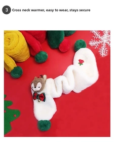 Detail of plush white faux fur Christmas scarf with reindeer doll and green pom-poms