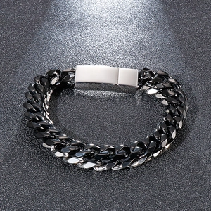 Macro detail of mixed black and silver stainless steel Cuban chain with square clasp