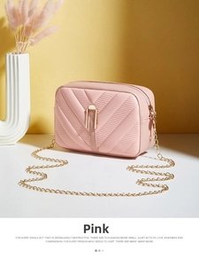 Detail of pink quilted PU leather bag with gold chain strap and metal bar closure