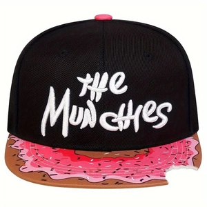 Detailed embroidery of THE MUNCHIES text on a black flat brim hat with donut pattern