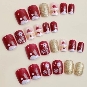 Short round Christmas press-on nails with red snowflake and Santa Claus designs