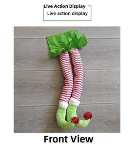 Detailed view of striped Christmas elf legs decoration on a grey wood texture surface