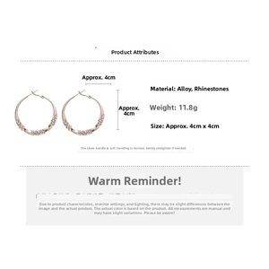 Detail view of 4cm rose gold geometric hoop earrings with crystal settings and silver pins