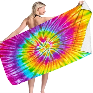 Detail of soft microfiber beach towel showing vibrant colorful tie-dye patterns on the front