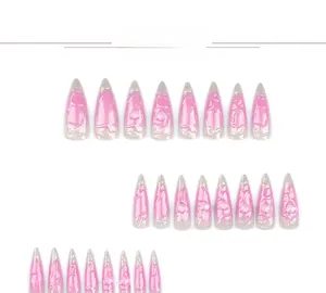Detailed view of pink cat-eye stiletto press-on nails with 3D embossed heart textures
