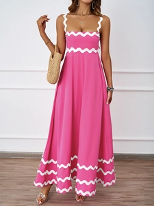 Detail of summer pink maxi dress showing white wavy scallop trim and breezy fabric