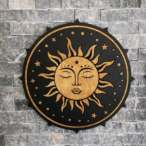 Round wooden celestial sun and stars wall hanging art with natural grain on brick background