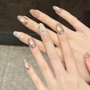Japanese style cat-eye press-on nails with golden glitter and 3D floral details