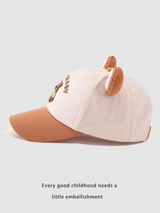 Close-up of children's baseball cap with plush ears and embroidered baby bear detail