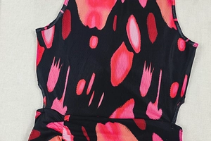 Detail of artistic red pink and black abstract print on sleeveless knit dress fabric