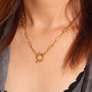 Close-up of 18K gold-plated paperclip chain necklace with a spring ring clasp on a model