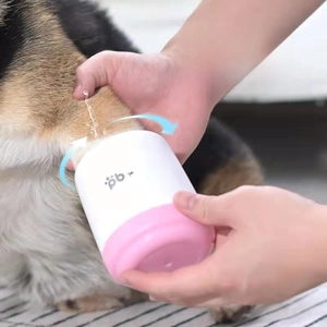 Action shot of the portable pet paw cleaner cup washing a dog's foot with water splashes