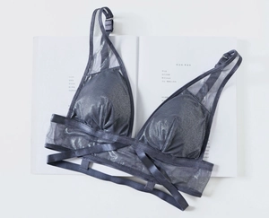 Detail of silver silk and sheer mesh bralette with criss-cross bandage design