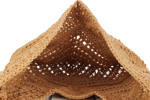 Detailed close-up of light brown handmade straw woven bag with hollow mesh texture