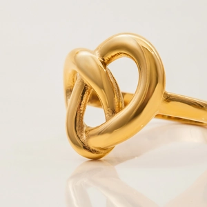 Minimalist knot design titanium steel ring in gold finish with mirror reflection effect