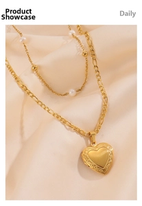 Close-up of gold 18k layered pearl necklace with engraved heart locket on satin