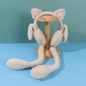 Detail of plush beige ear muffs with pink glittery cat ears and long hanging paws