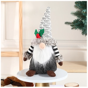 Close-up of Nordic Christmas gnome with knitted hat and holly berry detail on white stand