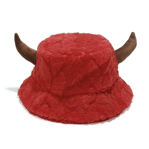 Detailed macro view of plush red Christmas hat with soft brown reindeer horn texture