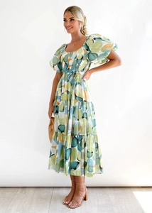 Detail of green geometric print dress with smocked bodice and layered cake skirt