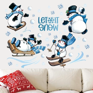 Winter snowman wall stickers with Let It Snow text above a sofa for Christmas decor