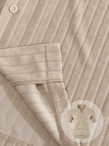 Detailed macro view of khaki waffle knit fabric texture on men's short sleeve shirt