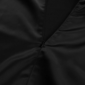 Detail shot of the invisible zipper sewing on smooth black satin long sleeve dress