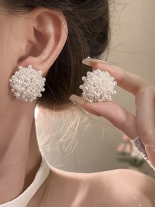 Detailed view of large cluster pearl stud earrings with elegant French vintage style