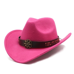 Detail of rose red felt cowboy hat featuring leather band and vintage metal flower