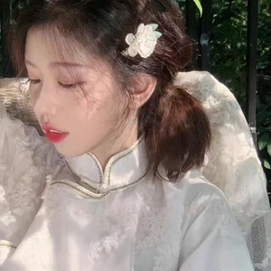 Elegant white camellia hair clip worn by a model in a vintage French romantic style