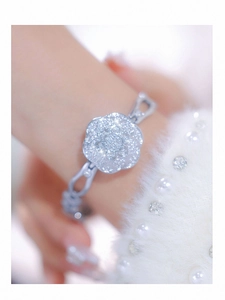 Macro shot of silver camellia flower bracelet watch with sparkling crystal inlay detail