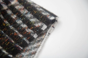 Macro shot of brushed knit fabric with colorful plaid pattern and soft fuzzy texture