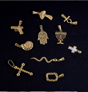 Detailed flat lay of ten 24K gold plated stainless steel charms in assorted shapes