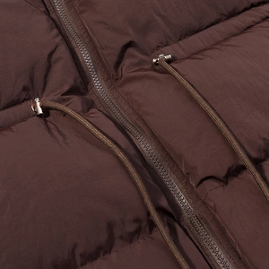 Deep brown quilted jacket with high-quality zipper and metal drawstring detail