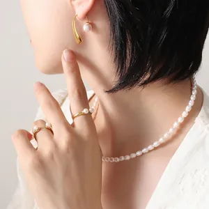 Elegant minimalist pearl jewelry set with gold hook earrings, rings and necklace